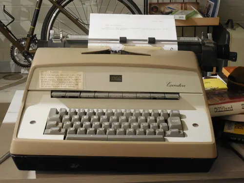 Photo of an IBM Model D Executive electric typewriter on a coffee table.