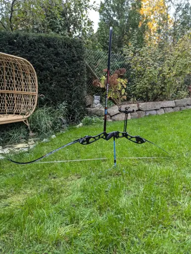 An olympic recurve bow on a stand.