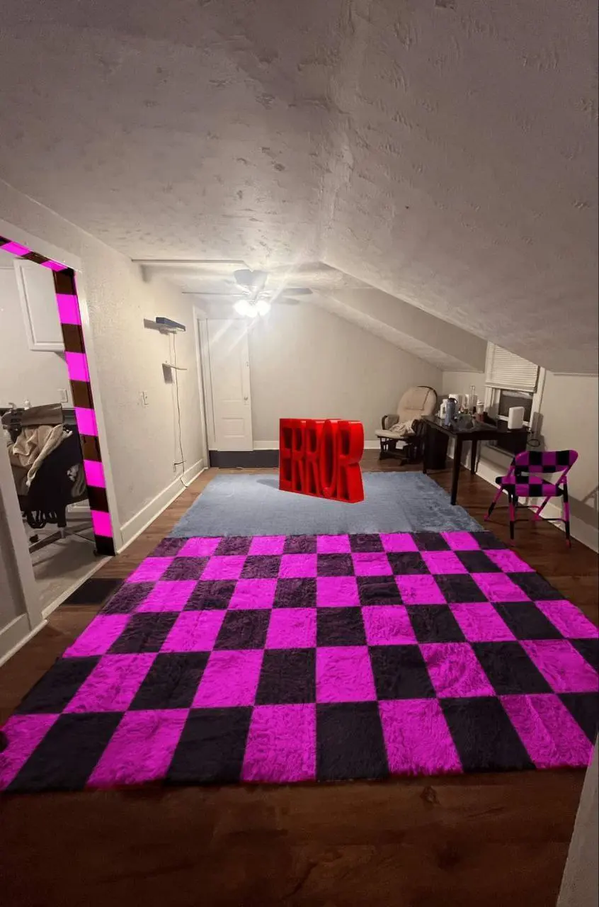 Second floor room, with the source/gmod "missing texture" purple-black checkerboard patter on the rug, chair, and door frame, and a red "Error" mesh in the middle of the room.