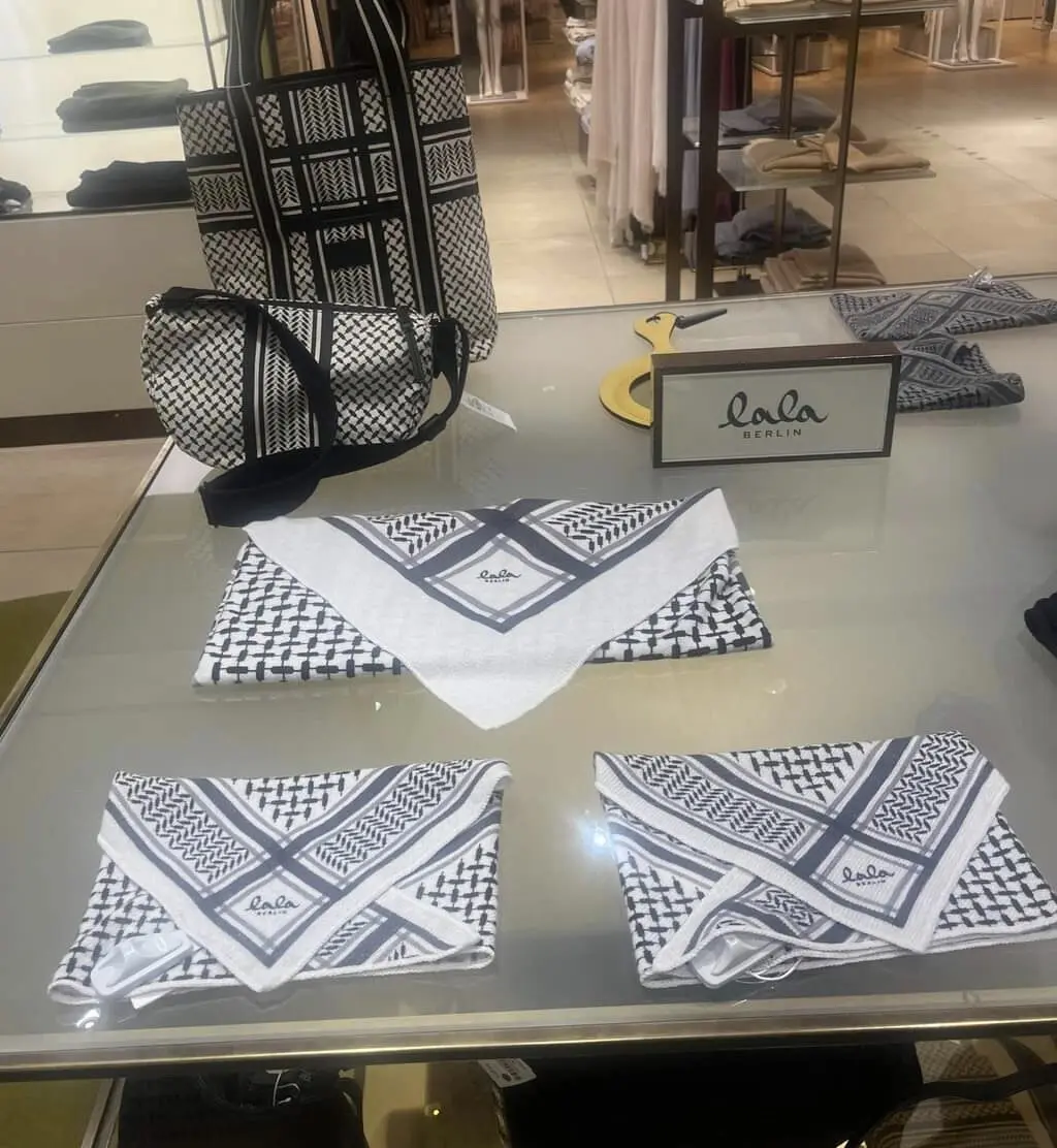 Another fashion stall in a department store with shawls and bags with black and white checker/grid motifs 